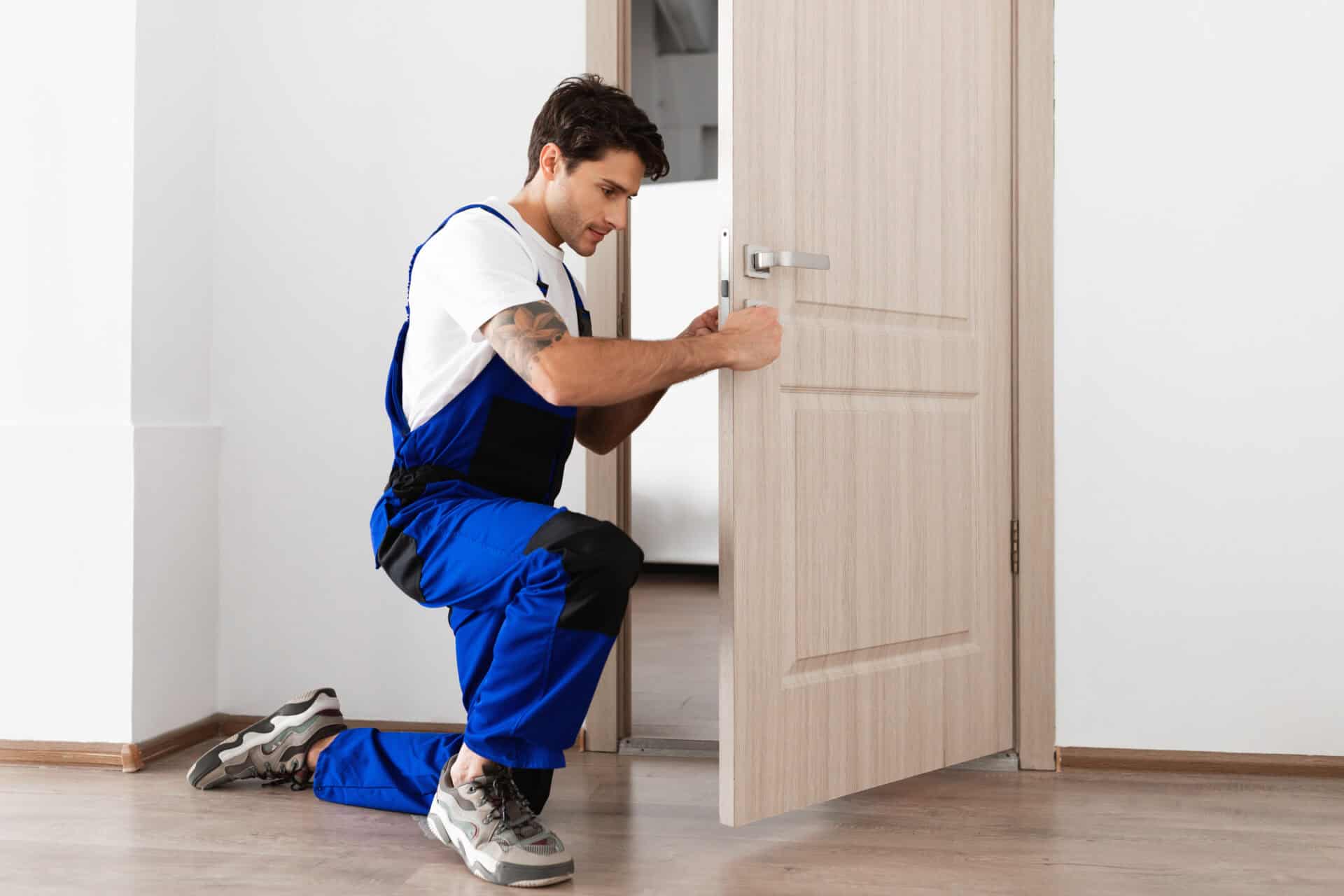 Carpenter professionally fitting an internal door in a Glasgow home