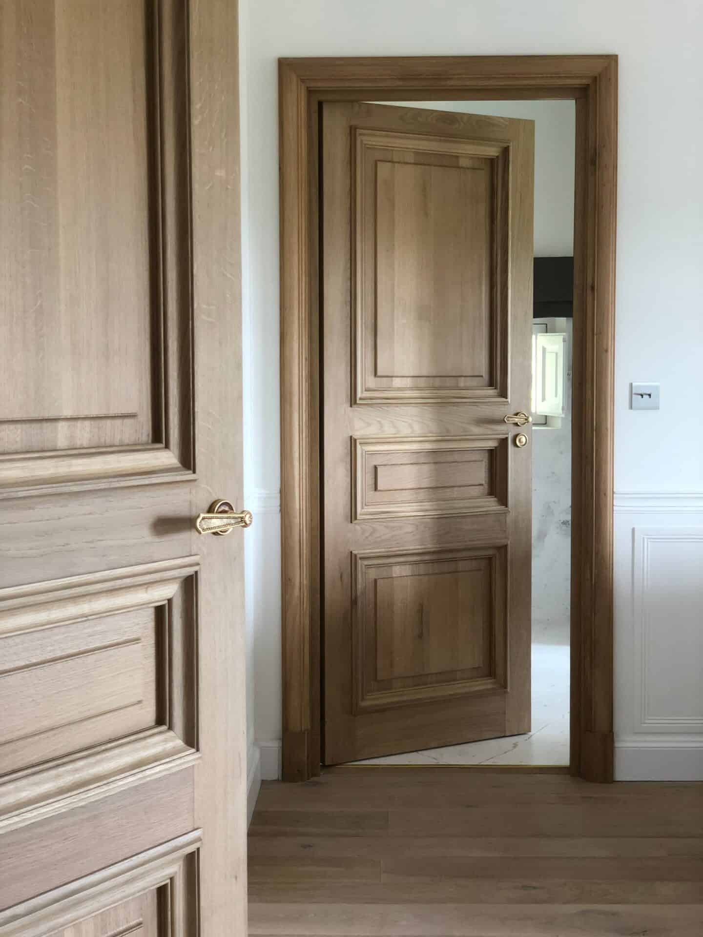 Traditional timber internal doors with matching wooden frames and architraves
