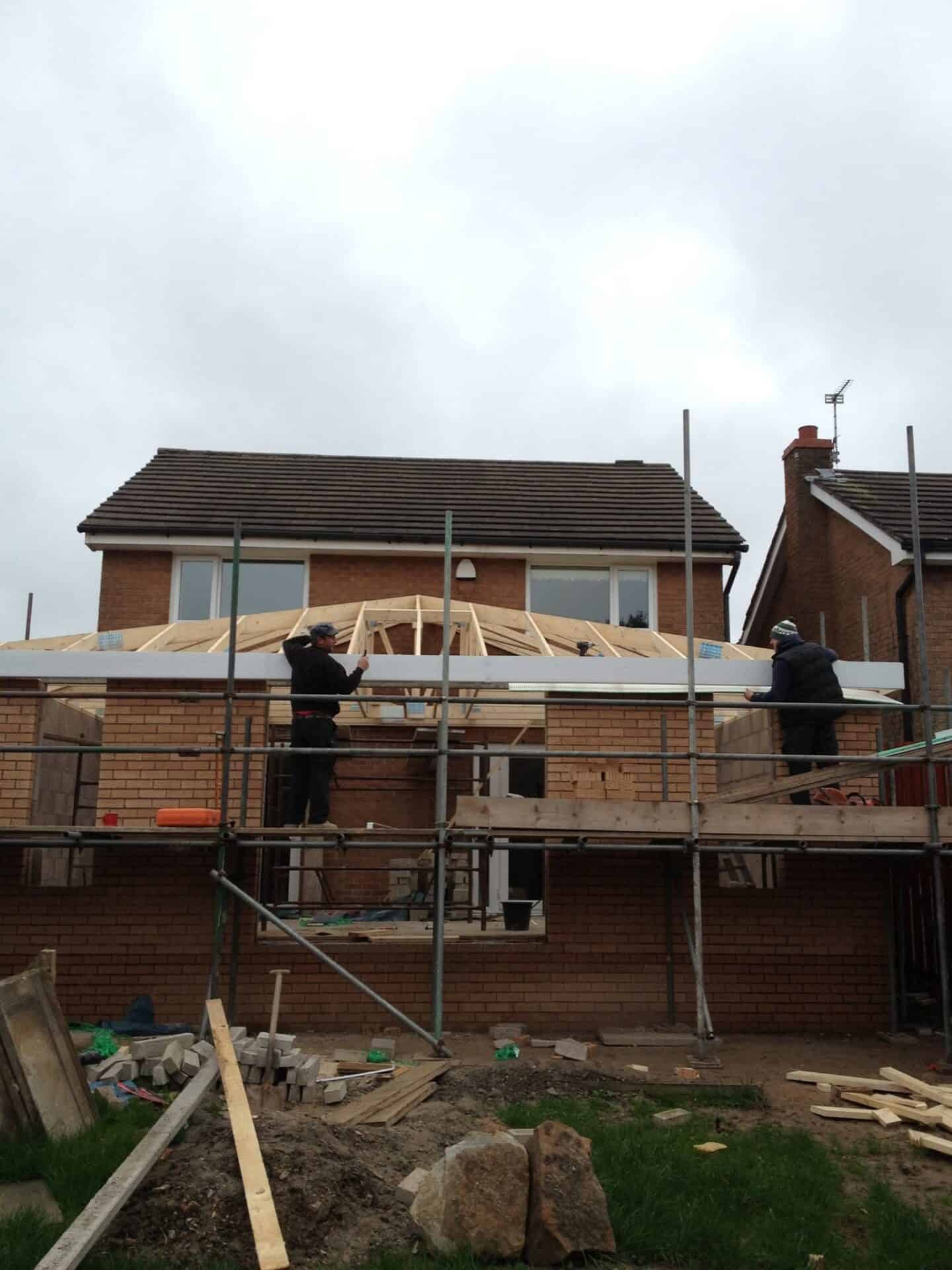 House extension in Glasgow under construction with timber roof trusses and scaffolding